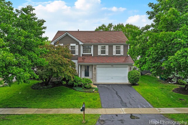 996 Highgate Ln, Grayslake, IL 60030 - traditional-style house featuring a garage, driveway, and a front yard
