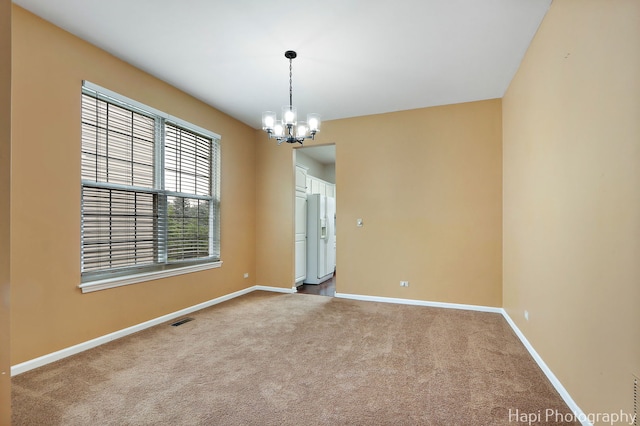 996 Highgate Ln, Grayslake, IL 60030 - spare room featuring a chandelier and light colored carpet