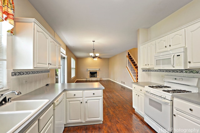996 Highgate Ln, Grayslake, IL 60030 - kitchen with white appliances, a peninsula, dark wood-style floors, and white cabinets