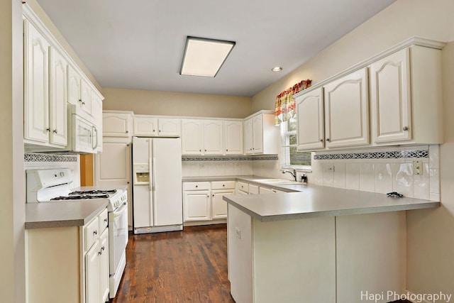 996 Highgate Ln, Grayslake, IL 60030 - kitchen with white appliances, a peninsula, backsplash, dark wood-style floors, and white cabinetry