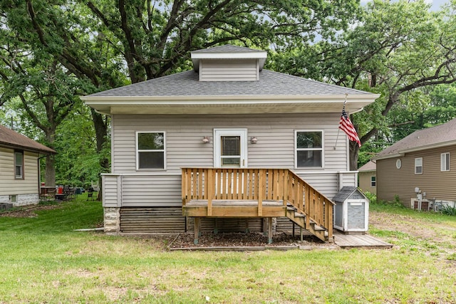 909 Woods Ave, Joliet, IL 60436 - rear view of property with a shingled roof, a wooden deck, and a lawn