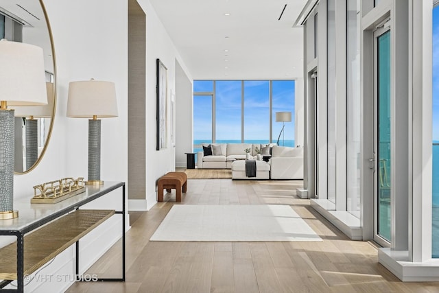 363 E Wacker Dr Unit 7501, Chicago, IL 60601 - hall featuring wood finished floors, a wall of windows, and a water view