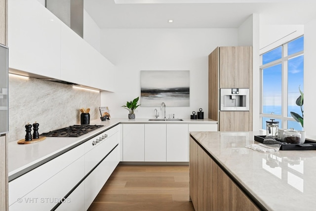 363 E Wacker Dr Unit 7501, Chicago, IL 60601 - kitchen with modern cabinets, gas cooktop, light countertops, a sink, and white cabinets