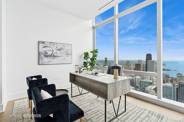 363 E Wacker Dr Unit 7501, Chicago, IL 60601 - office area with floor to ceiling windows, wood finished floors, a water view, a city view, and baseboards