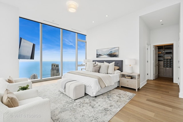 363 E Wacker Dr Unit 7501, Chicago, IL 60601 - bedroom with a wall of windows, light wood-style flooring, a high ceiling, and recessed lighting
