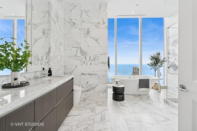 363 E Wacker Dr Unit 7501, Chicago, IL 60601 - full bathroom with a wall of windows, a freestanding bath, double vanity, toilet, and a water view