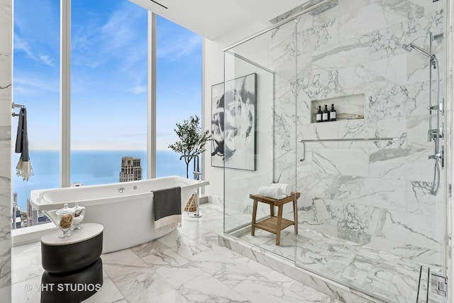 363 E Wacker Dr Unit 7501, Chicago, IL 60601 - full bathroom featuring marble tiled flooring, a freestanding tub, a marble finish shower, and a water view
