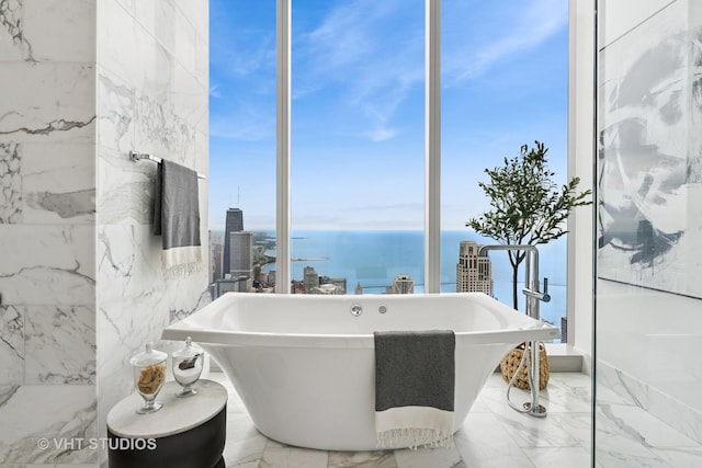 363 E Wacker Dr Unit 7501, Chicago, IL 60601 - full bathroom featuring a freestanding tub, marble tiled floors, and a water view