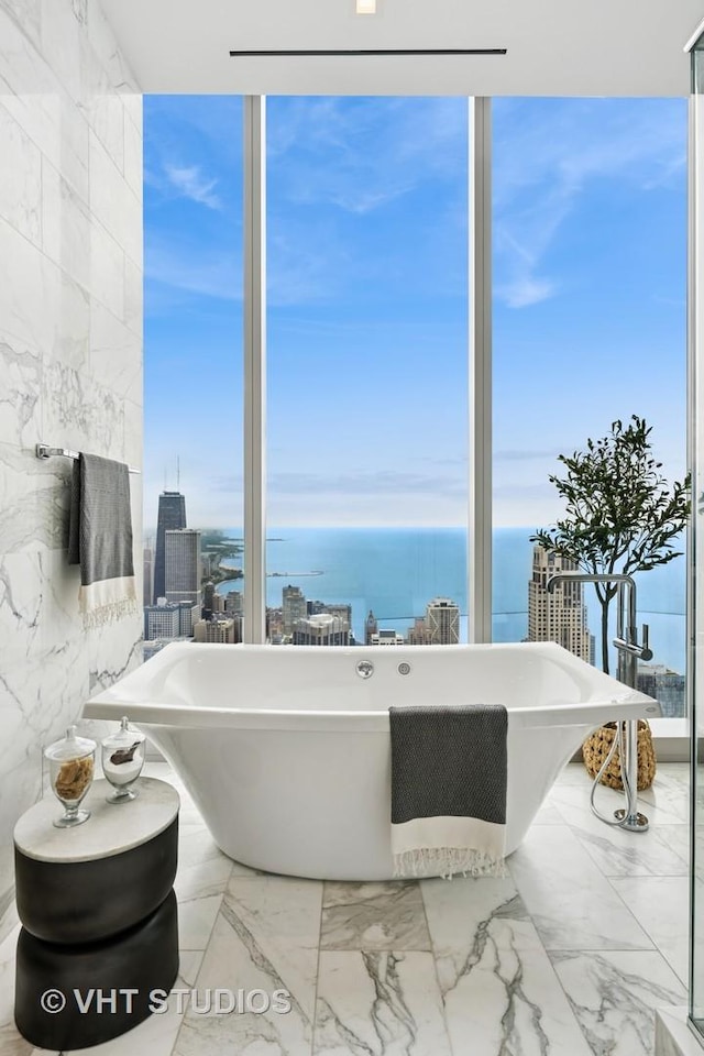 363 E Wacker Dr Unit 7501, Chicago, IL 60601 - bathroom with marble finish flooring, a water view, a freestanding tub, a wall of windows, and a view of city