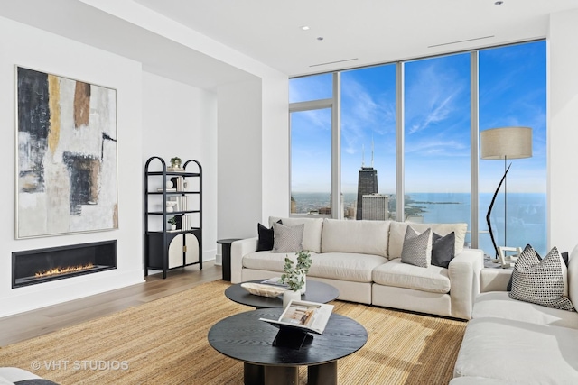 363 E Wacker Dr Unit 7501, Chicago, IL 60601 - living area featuring wood finished floors, floor to ceiling windows, a glass covered fireplace, and a water view