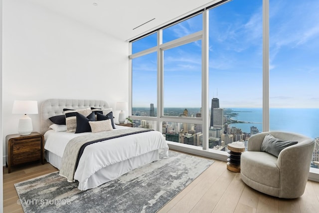 363 E Wacker Dr Unit 7501, Chicago, IL 60601 - bedroom with expansive windows, a water view, wood finished floors, and a city view