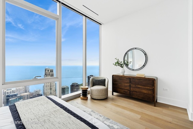 363 E Wacker Dr Unit 7501, Chicago, IL 60601 - bedroom featuring expansive windows, baseboards, wood finished floors, and a water view