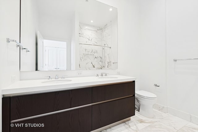 363 E Wacker Dr Unit 7501, Chicago, IL 60601 - bathroom featuring double vanity, marble look tiles, a marble finish shower, toilet, and baseboards