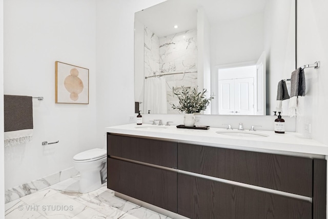 363 E Wacker Dr Unit 7501, Chicago, IL 60601 - bathroom featuring double vanity, marble look tile flooring, toilet, a marble finish shower, and baseboards