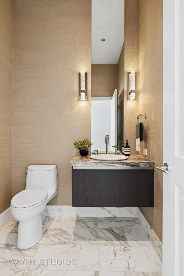 363 E Wacker Dr Unit 7501, Chicago, IL 60601 - half bathroom with vanity, toilet, and marble finish floors