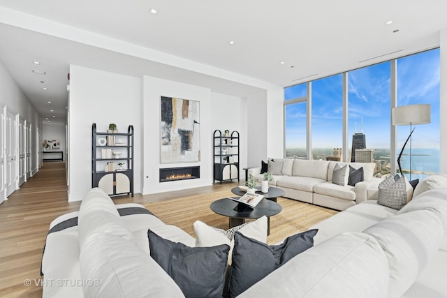 363 E Wacker Dr Unit 7501, Chicago, IL 60601 - living area with light wood-type flooring, a glass covered fireplace, floor to ceiling windows, and recessed lighting