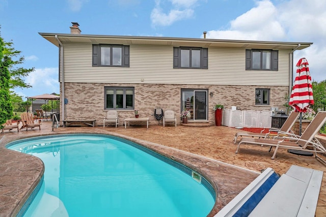 19415 Lisadell Dr, Tinley Park, IL 60487 - rear view of house featuring brick siding, an outdoor pool, a chimney, and a patio