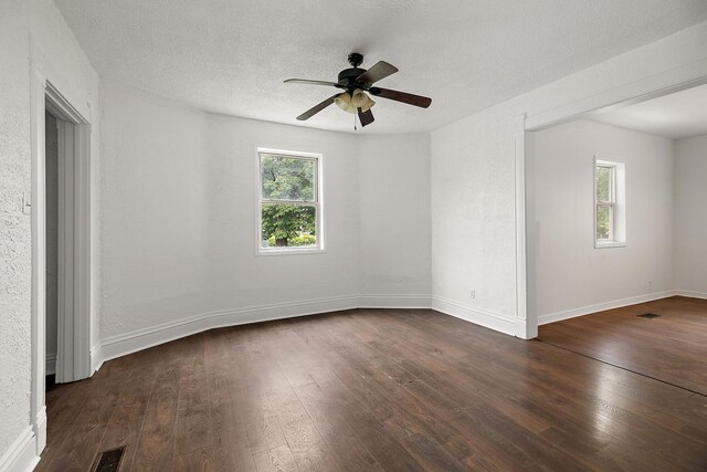 175 N Washington Ave, Kankakee, IL 60901 - empty room featuring dark wood-type flooring, a ceiling fan, baseboards, and a textured ceiling
