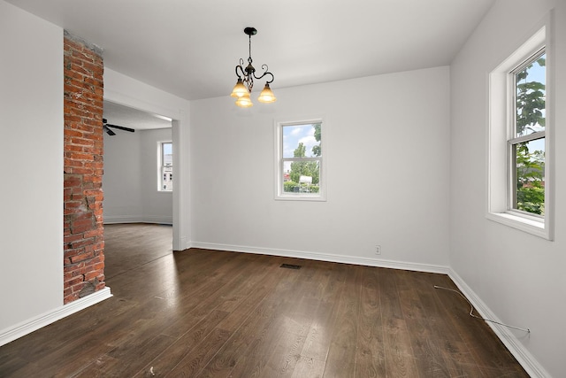 175 N Washington Ave, Kankakee, IL 60901 - empty room featuring healthy amount of natural light, dark wood finished floors, baseboards, and a chandelier