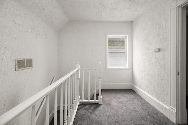 175 N Washington Ave, Kankakee, IL 60901 - hallway with an upstairs landing, a textured wall, carpet flooring, a textured ceiling, and baseboards