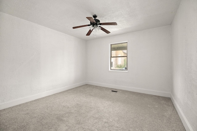 175 N Washington Ave, Kankakee, IL 60901 - carpeted empty room featuring a textured ceiling, baseboards, a textured wall, and ceiling fan
