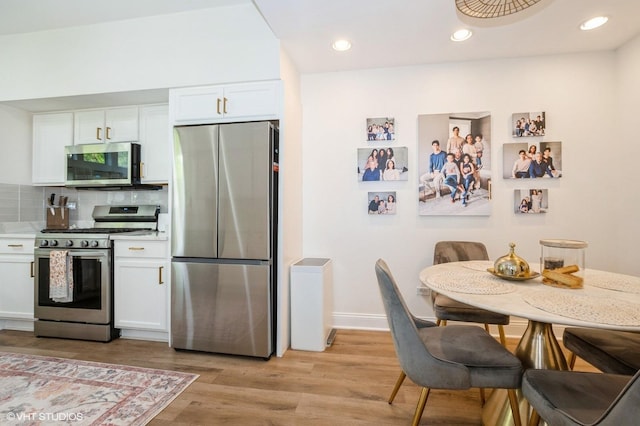 16657 S Windsor Ln Unit 16657, Lockport, IL 60441 - kitchen with appliances with stainless steel finishes, white cabinetry, light wood-type flooring, tasteful backsplash, and light countertops