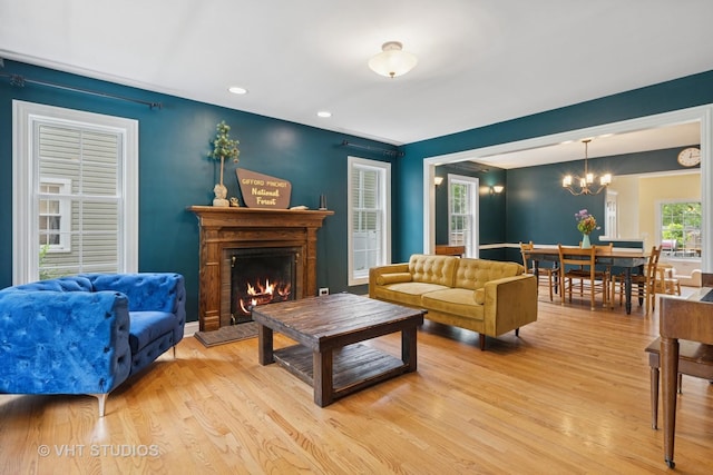720 Beaver Rd, Glenview, IL 60025 - living area with light wood-type flooring, a lit fireplace, a chandelier, and recessed lighting