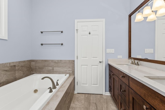 1237 W Farwell Ave Unit 2W, Chicago, IL 60626 - bathroom with double vanity, a jetted tub, and marble finish floors