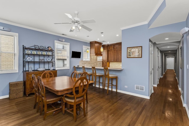 1237 W Farwell Ave Unit 2W, Chicago, IL 60626 - dining space with arched walkways, dark wood-style flooring, baseboards, crown molding, and a ceiling fan