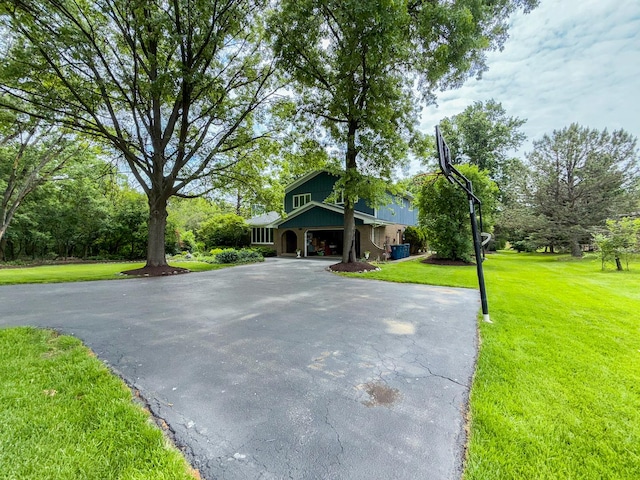 12533 S Iroquois Rd, Palos Park, IL 60464 - view of front of house featuring asphalt driveway, a front yard, and a garage