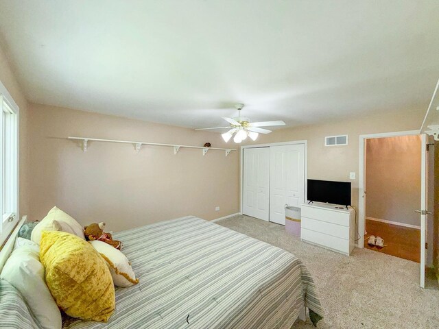 12533 S Iroquois Rd, Palos Park, IL 60464 - bedroom with a closet, light carpet, a ceiling fan, and baseboards