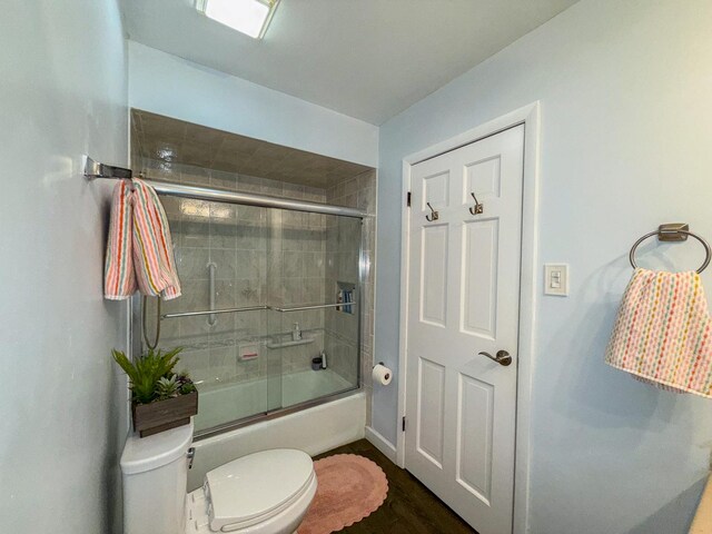 12533 S Iroquois Rd, Palos Park, IL 60464 - full bathroom with toilet, combined bath / shower with glass door, wood finished floors, and baseboards
