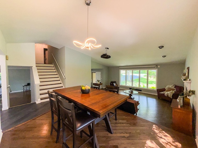 12533 S Iroquois Rd, Palos Park, IL 60464 - dining room with stairs, dark wood-style flooring, a chandelier, and vaulted ceiling