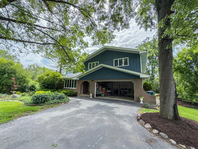 12533 S Iroquois Rd, Palos Park, IL 60464 - split level home with asphalt driveway, a garage, and brick siding