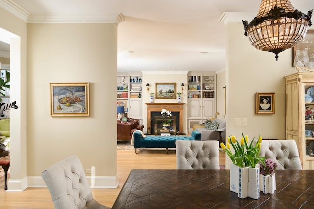635 W Sheridan Rd Unit 3, Chicago, IL 60613 - dining area with a fireplace, wood finished floors, crown molding, built in shelves, and baseboards