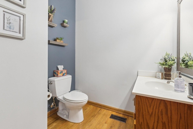 310 Westhaven Cir, Geneva, IL 60134 - half bath with vanity, toilet, wood finished floors, and baseboards