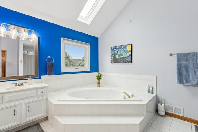 310 Westhaven Cir, Geneva, IL 60134 - bathroom featuring a skylight, vanity, a tub with jets, tile patterned floors, and high vaulted ceiling