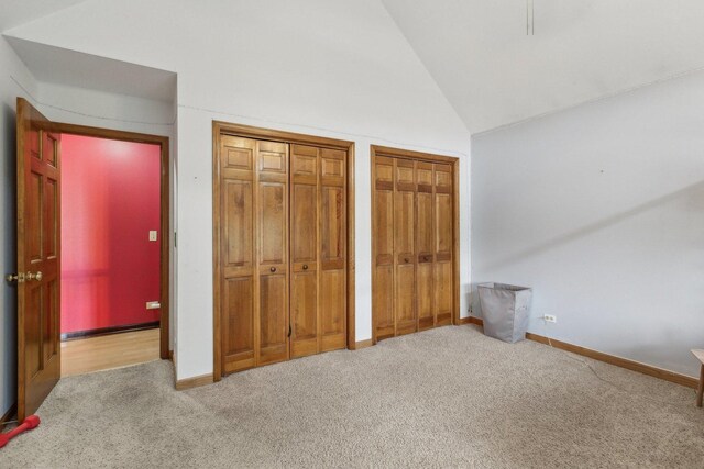 310 Westhaven Cir, Geneva, IL 60134 - unfurnished bedroom with carpet floors, two closets, vaulted ceiling, and baseboards