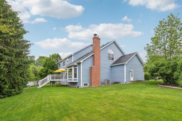310 Westhaven Cir, Geneva, IL 60134 - back of property featuring a lawn, a wooden deck, cooling unit, and a chimney
