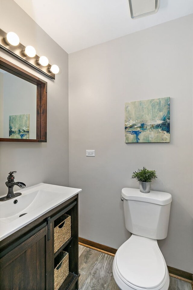 36 Shore Dr, Schaumburg, IL 60193 - bathroom with wood finished floors, baseboards, vanity, and toilet