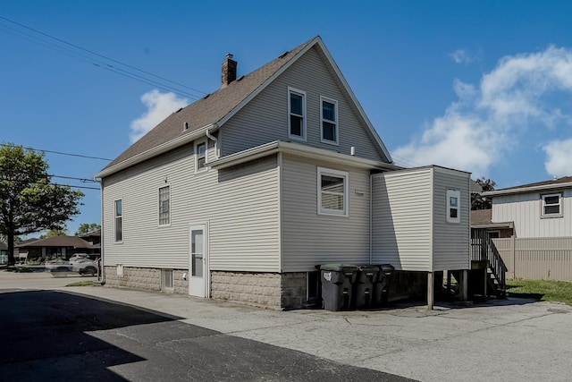 1970 E 170th St, South Holland, IL 60473 - view of home's exterior featuring a chimney and a shingled roof