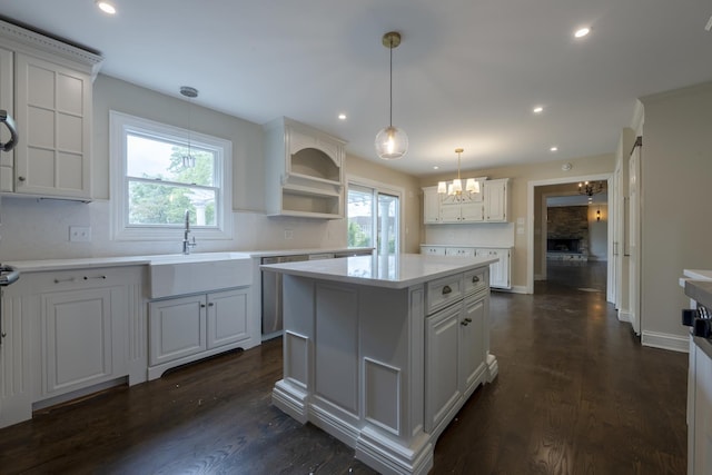 3745 Whirlaway Dr, Northbrook, IL 60062 - kitchen with open shelves, a sink, a chandelier, light countertops, and a center island