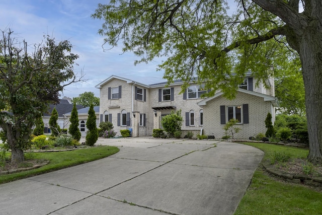 3745 Whirlaway Dr, Northbrook, IL 60062 - view of front of home featuring brick siding, curved driveway, and a front yard