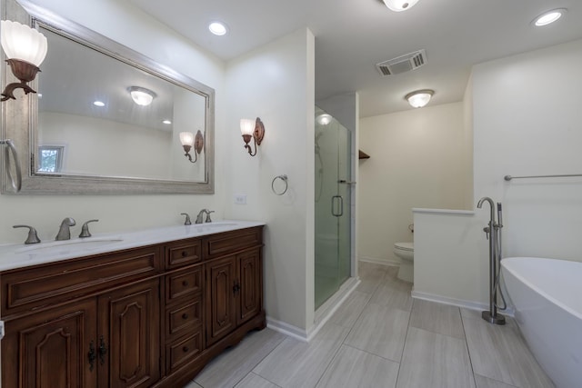 3745 Whirlaway Dr, Northbrook, IL 60062 - bathroom with a stall shower, double vanity, a freestanding tub, toilet, and baseboards