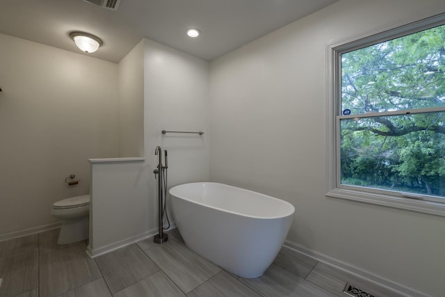 3745 Whirlaway Dr, Northbrook, IL 60062 - full bath with a freestanding tub, toilet, baseboards, and recessed lighting