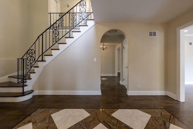 3745 Whirlaway Dr, Northbrook, IL 60062 - stairway featuring arched walkways, wood finished floors, and baseboards