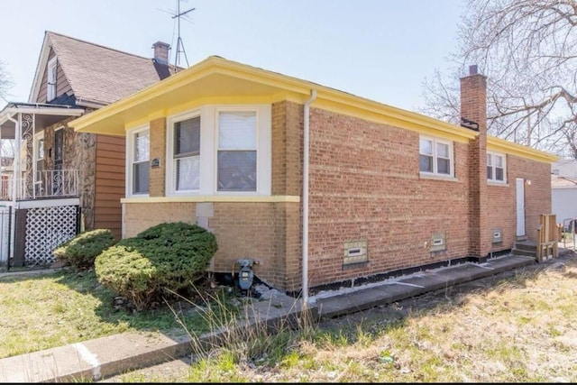 9032 S University Ave, Chicago, IL 60619 - view of side of home featuring brick siding, a chimney, and a yard