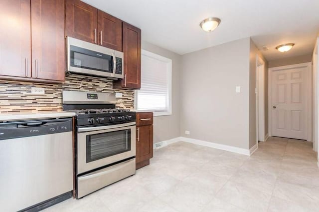 9032 S University Ave, Chicago, IL 60619 - kitchen with appliances with stainless steel finishes, backsplash, light countertops, and baseboards