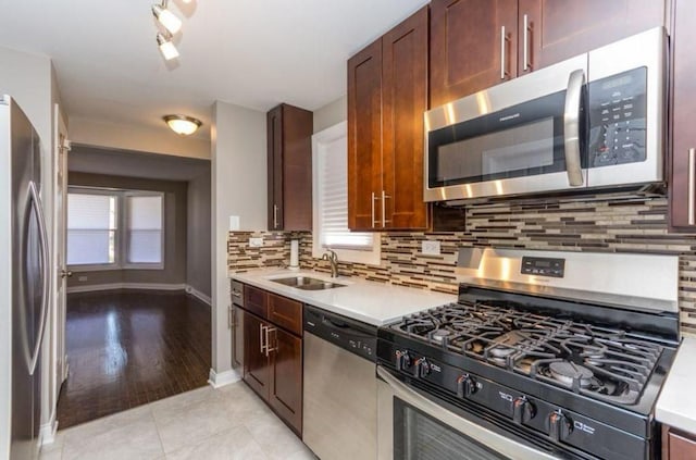 9032 S University Ave, Chicago, IL 60619 - kitchen with appliances with stainless steel finishes, a sink, light countertops, and decorative backsplash