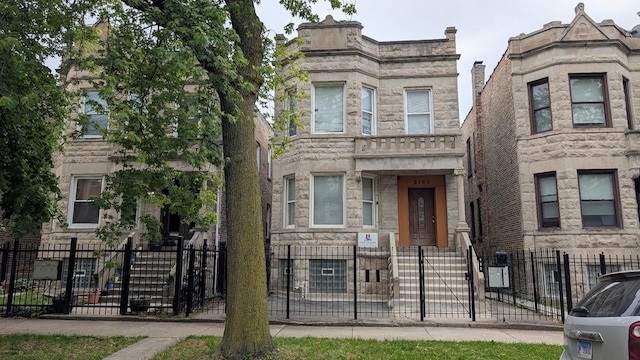 2160 S Millard Ave, Chicago, IL 60623 - view of front of property with a fenced front yard and stone siding